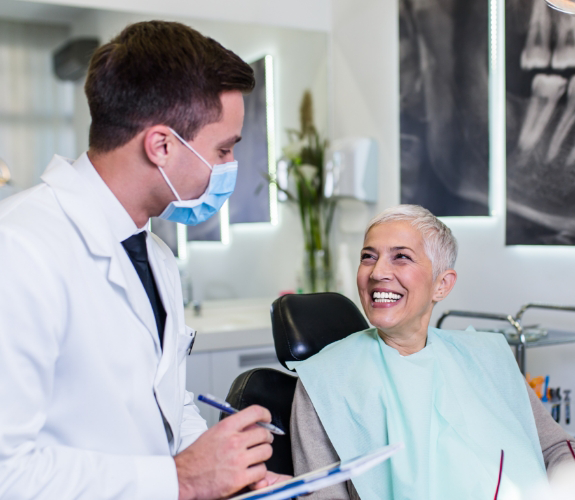 Palm Coast dentist talking to senior dental patient