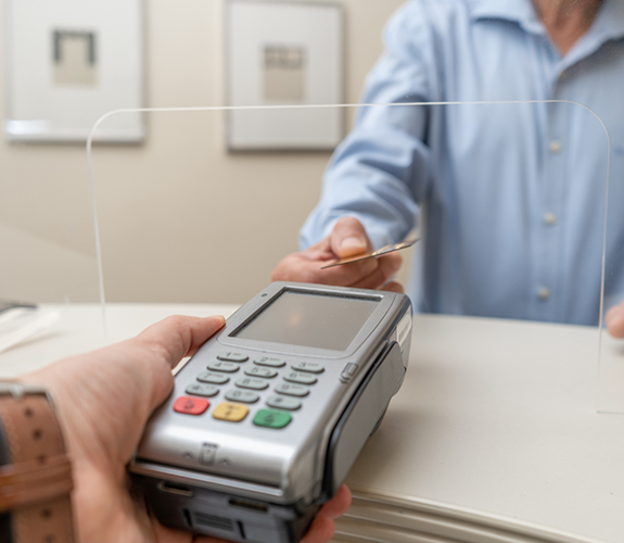 Holding out credit card reader for patient