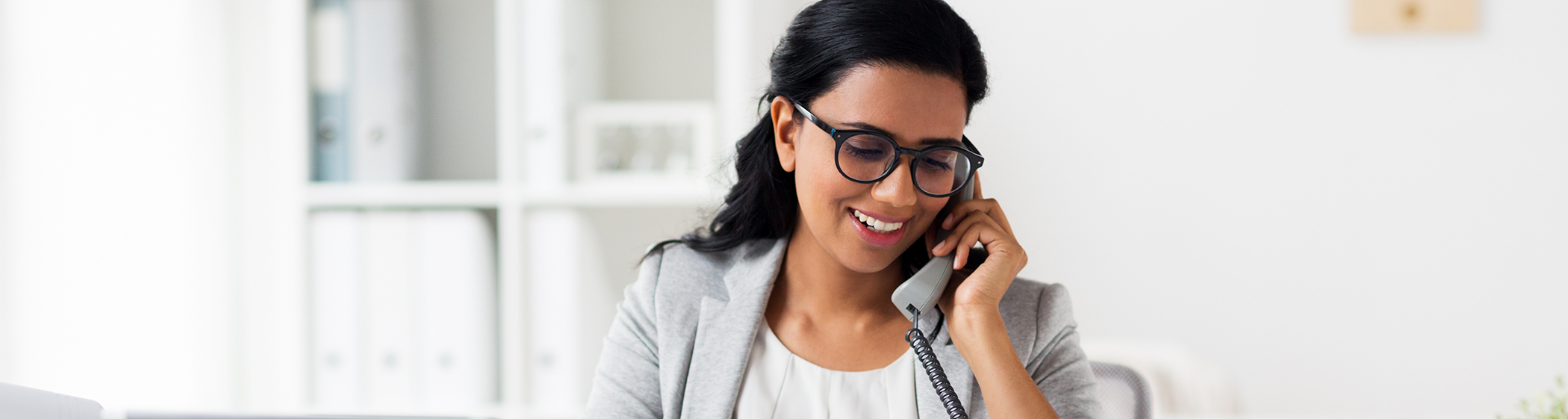 Woman with glasses talking on cell phone