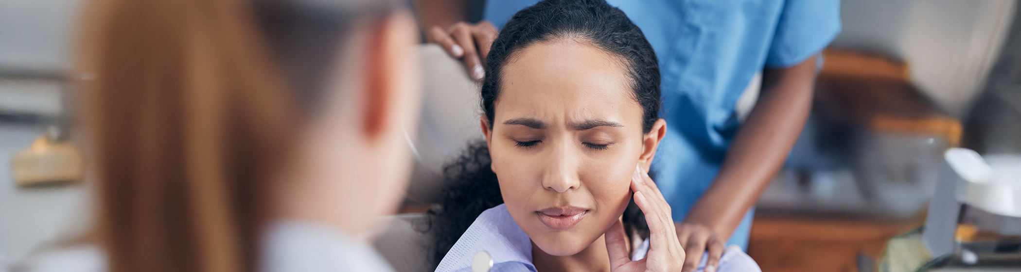 Woman rubbing her jaw in pain