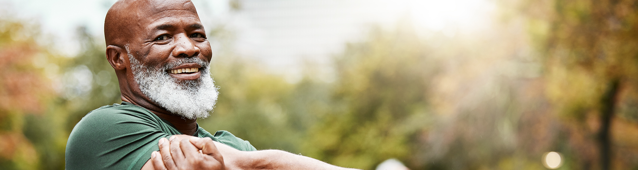 Bearded man standing outside and smiling