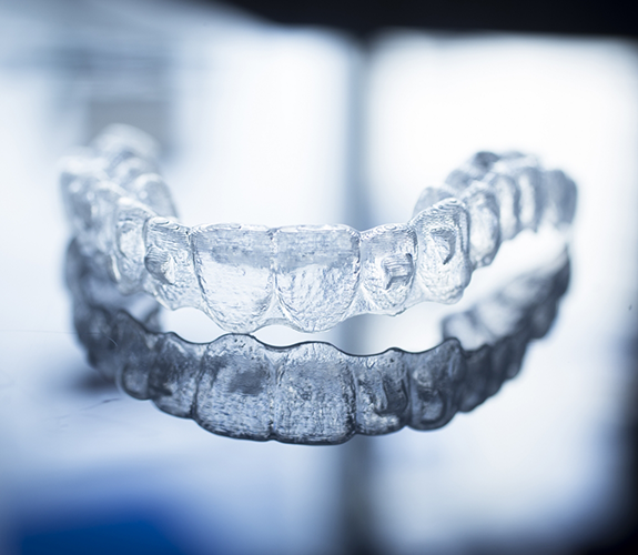 Clear aligner sitting on reflective surface