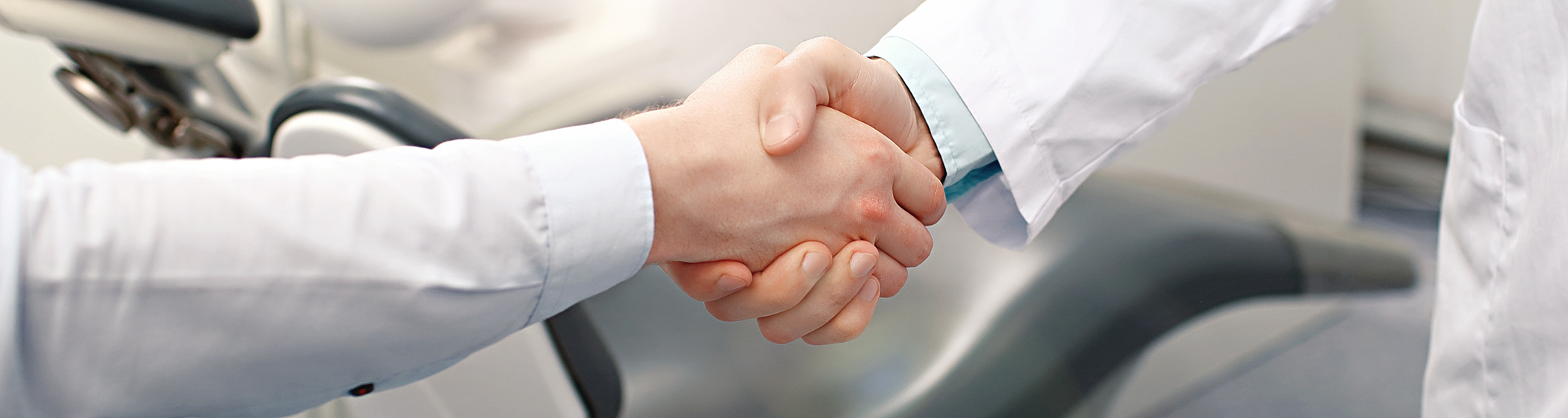 Close-up of patient and Palm Coast dentist shaking hands