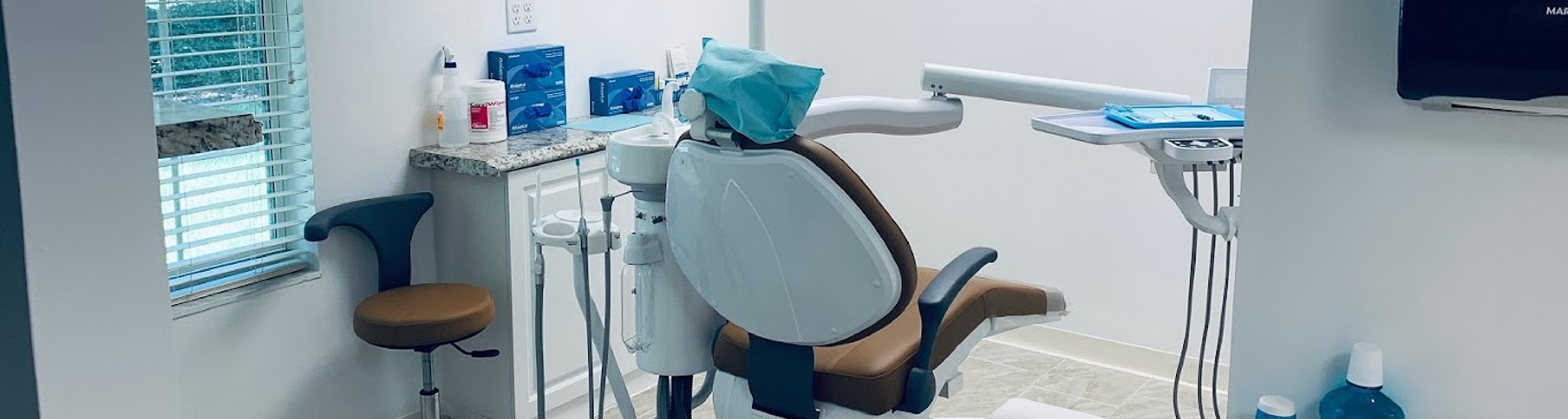 Dental chair with blue cover on headrest