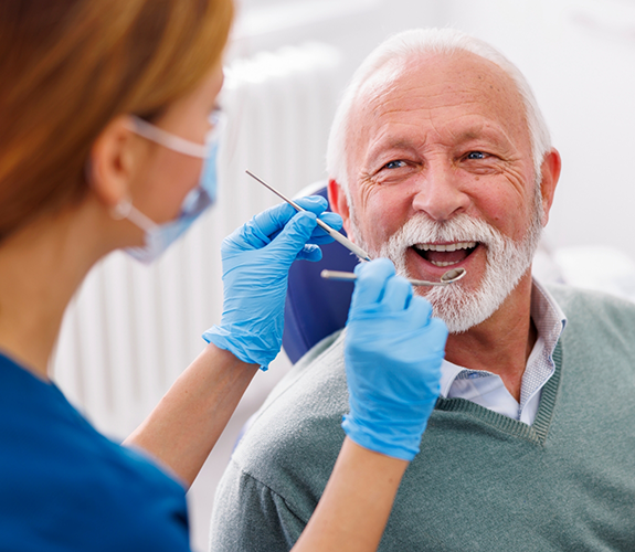 Senior man receiving dental checkup for preventive dentistry in Palm Coast