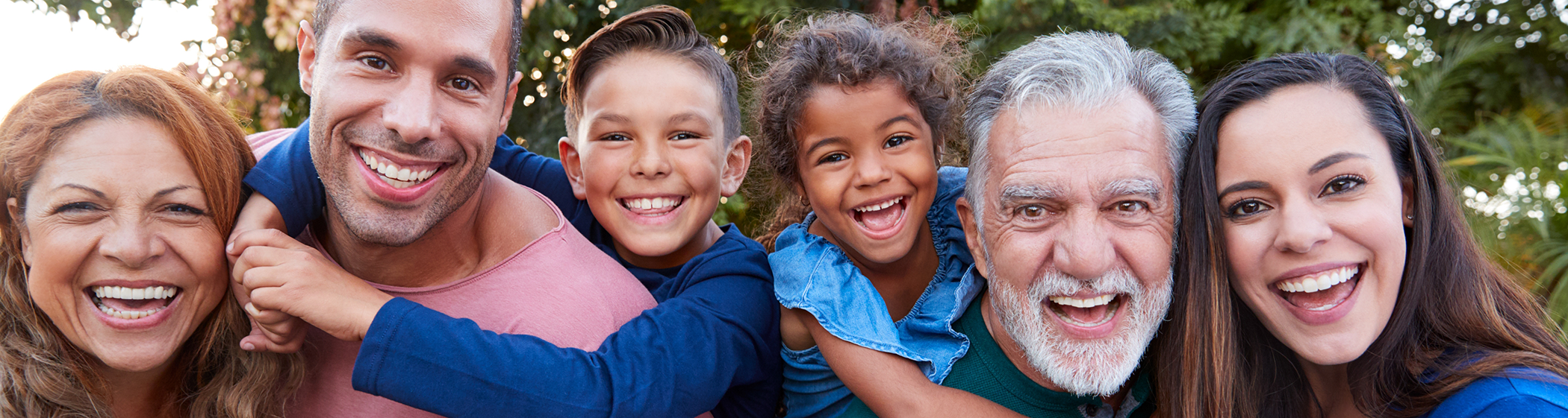 Row of children and adults smiling